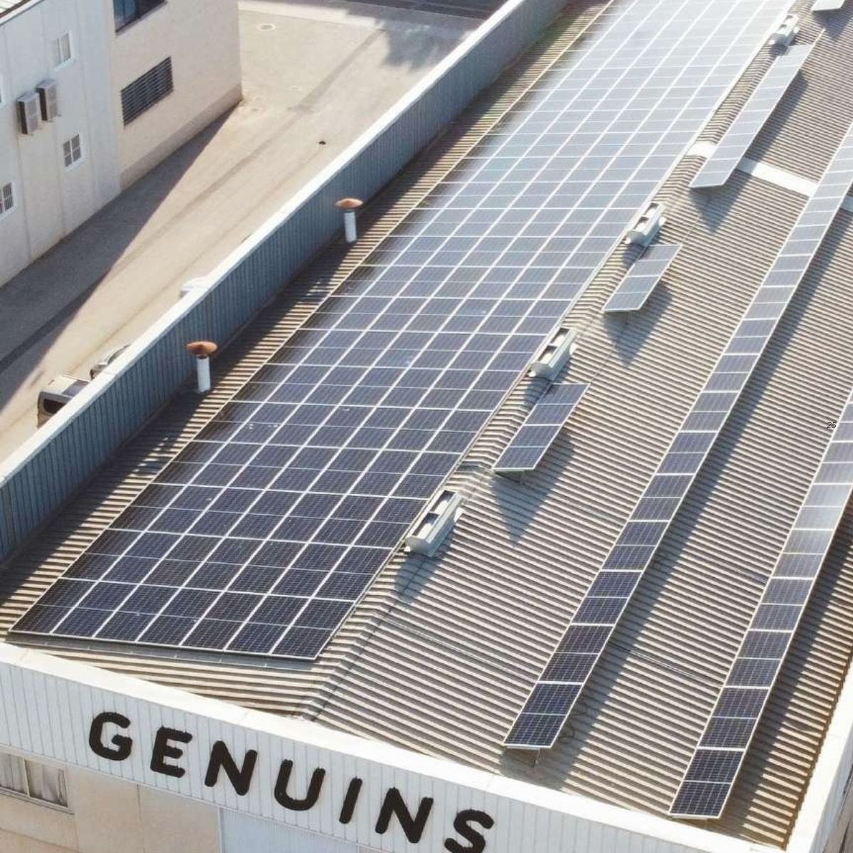 Eco Friendly Solar panels installed on a roof with 'GENUINS' branding.
